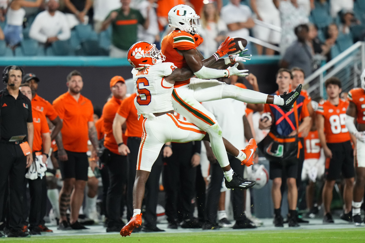 Oct 21, 2023; Miami Gardens, Florida, USA; Miami Hurricanes wide receiver Colbie Young (4) makes a catch against Clemson Tigers cornerback Sheridan Jones (6) during the fourth quarter at Hard Rock Stadium. Mandatory Credit: Rich Storry-USA TODAY Sports